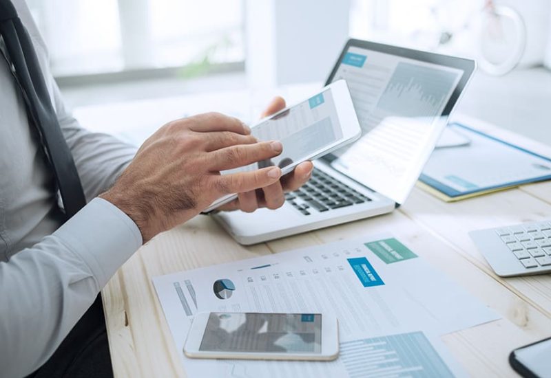 Professional businessman working at desk and using a touch screen tablet, technology and communication concept