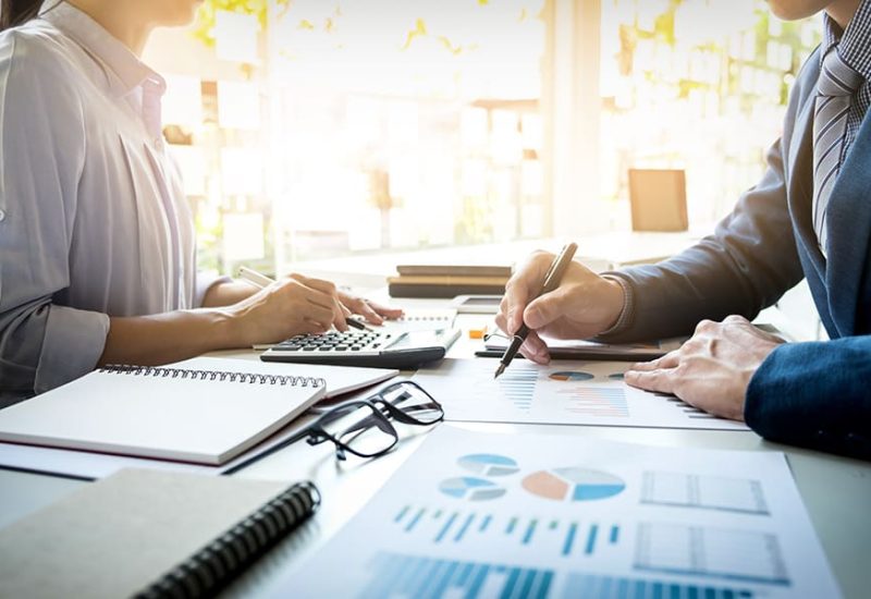 business man financial inspector and secretary making report, calculating or checking balance. Internal Revenue Service inspector checking document. Audit concept